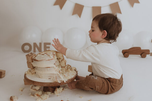 Cake smash celebrating little boys first birthday