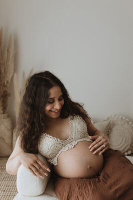 Mum to be sitting down celebrating her newest baby.