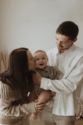 Parents an baby sharing a beautiful moment together during milestone session in Melbourne