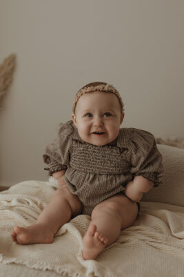 Baby girl laughing during a milestone photography session